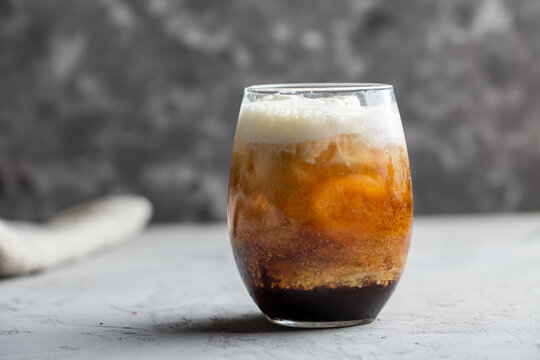 Ice cream with coffee cocktail in glass on grey background