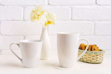 Whites cappuccino and coffee latte mug mockup with yellow orchid in vase and cookies in wicker basket