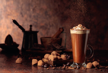 Truffles and glass of hot chocolate with whipped cream.