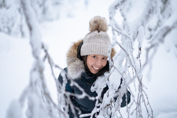 Fototapeta na wymiar Portrait of the young Asian woman in winter forest