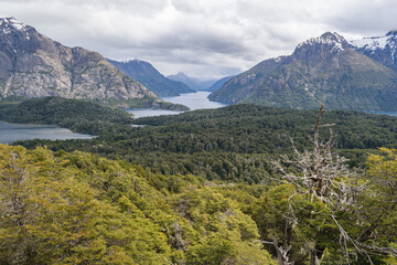 A cloudy day in the wilderness of Patagonia surrounded by mountains, water and trees seen from Cerro Llao Llao viewpoint