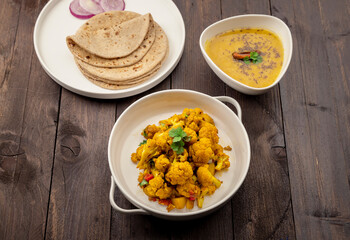 traditional indian meal lentil soup, flat bread and cauliflower vegetable, dal, roti and sabzi