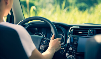 Asian woman driver driving off road car in the nature