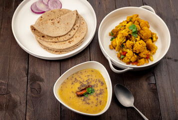 traditional indian meal lentil soup, flat bread and cauliflower vegetable, dal, roti and sabzi