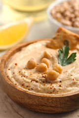 hummus in a wooden plate close up, chickpeas, croutons. Dishes of chickpeas, a vegetarian dish. 