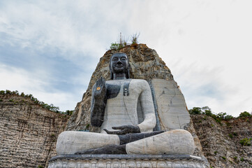 Fototapeta premium Suphan Buri / Thailand / August 15, 2020 : ( Rock Buddha ) Wat Khao Tham Thiam is the giant stone Buddha image in Suphanburi province.