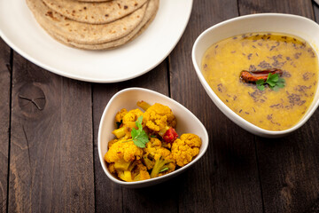 traditional indian meal lentil soup, flat bread and cauliflower vegetable, dal, roti and sabzi