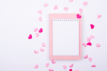 Notebook for wishlist with pink hearts on a white background. Mock up.