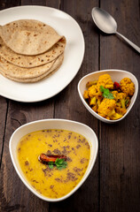 traditional indian meal lentil soup, flat bread and cauliflower vegetable, dal, roti and sabzi