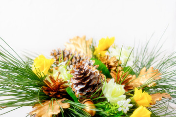 Christmas decor with golden cones and yellow silk roses