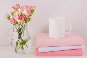 Coffee mug mockup with pink roses in glass jug
