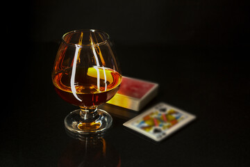Cognac glass and playing cards