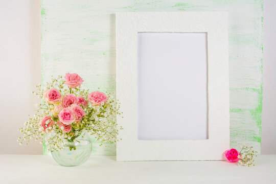 Frame mockup with roses in glass vase