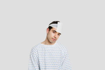 Sad male patient with bandage on head