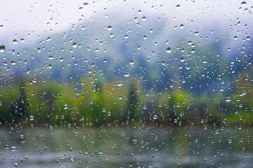 Lake view through window in rainy day