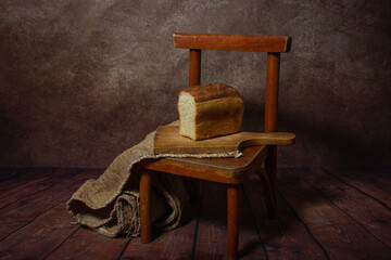 Bread on a wooden board. Still life with bread. Sliced bread. Bakery product