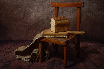 Bread on a wooden board. Still life with bread. Sliced bread. Bakery product
