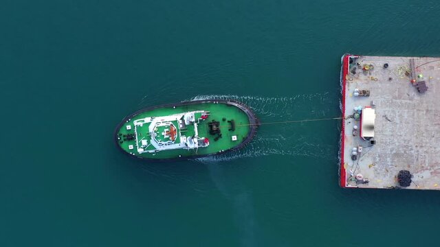 Tugboat pulling a large Barge, Aerial image.