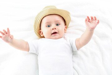 Cute baby boy smiling to the camera, lying on white background.