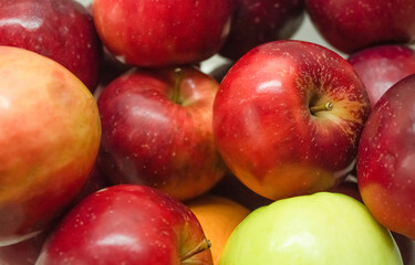 Fototapeta na wymiar Lots of red ripe apples close up 
