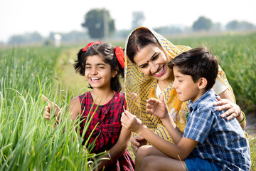 Rural mother with children in agricultural field