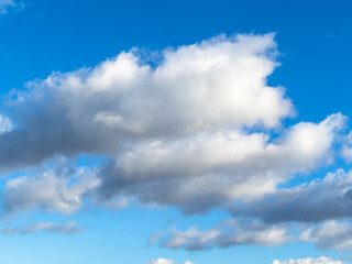 white and gray cumuli clouds in blue sky on sunny November day