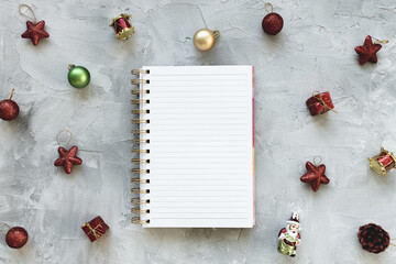 Notepad, Christmas decoration on desk workspace, gray background. Winter holidays preparation and lifestyle concept. To Do List template. Flat lay, top view, copy space