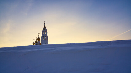 Church of the saints and God's builders at sunrise against the backdrop of a clear sky and withered...