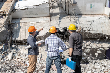 Demolition control supervisor and contractor discussing on demolish building.