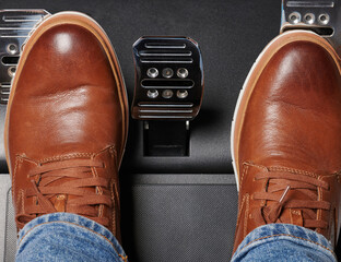 Legs on acceleration and clutch shiny metal car pedals