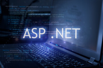 ASP .NET inscription against laptop and code background. Learn dot net programming language,...