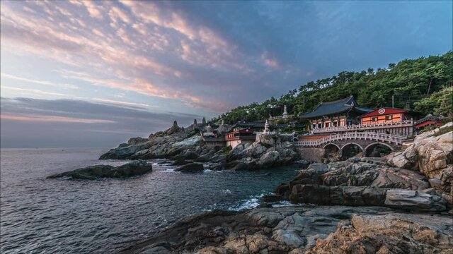 Time lapse morning view Haedong Yonggungsa Temple and Haeundae Sea at sunrise in Gijang-gun Busan, South Korea.Fish eye.Main hall of a Buddhist temple in the text.