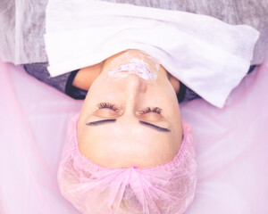 The girl's face during a facial rejuvenation procedure.