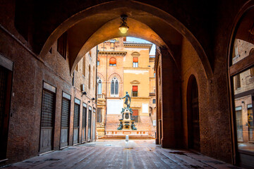Neptune fountain Bologna, Italy - medieval bricks town with archs. Sunrise moment  © Giampaolo
