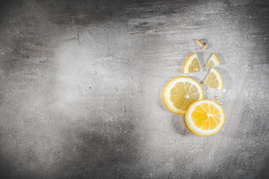 Lemon slice on gray table. Fresh citrous fruits piece, isolated with copyspace