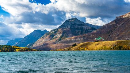 Middle Waterton Lake lakeshore in autumn foliage season sunny day morning. Blue sky, white clouds...