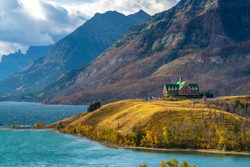 Middle Waterton Lake lakeshore in autumn foliage season sunny day morning. Blue sky, white clouds...