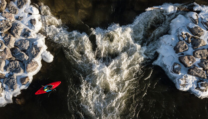kayaker on a river in the winter