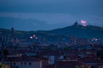 Celebratory fireworks for new year over San Luca Basilica or cathedral or church during last night of year. Christmas atmosphere. it is seen the asinelli tower and Saint Petronio, Bologna -Italy