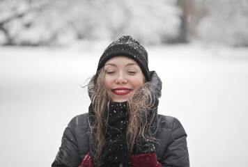 young woman with in a snowy park