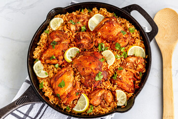 One Pan Spanish Chicken and Rice in a Skillet with Serving Spoon