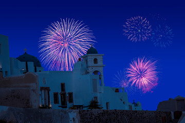 Celebratory fireworks for new year over orthodox white church in santorini during last night of...