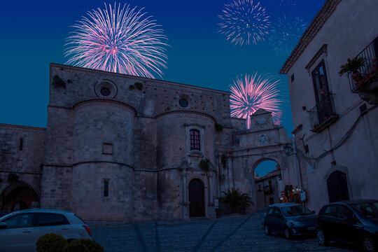 Celebratory fireworks for new year over Cathedral and byzantine church of Haghia Kyriake in village Gerace in Calabria,Italy during last night of year. Christmas atmosphere. 