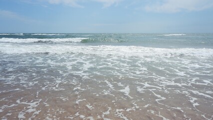 Clear sea water, wave and sand beach.