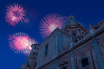 Celebratory fireworks for new year over pretoria baroque fountain in Palermo, Italy during last night of year. Christmas blue atmosphere 