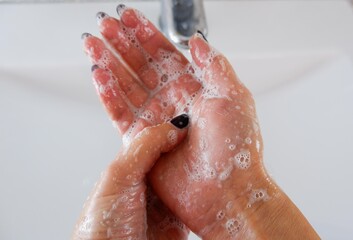 Fototapeta premium Partial view of woman washing hands at home.