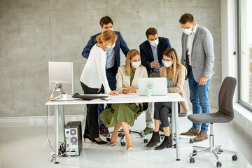 Group of business people have a meeting and working in office and wear masks as protection from coronavirus