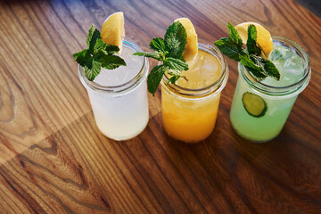Yellow and green colored. Close up view of fresh summer alcoholic cocktails on the wooden table