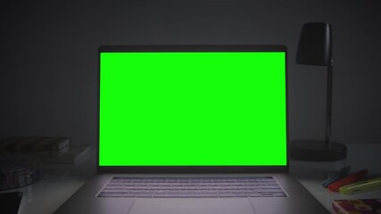 Home office setup with chroma key. Dolly out of laptop with green screen on a white desk. Perfect to put your own images or videos. Track corners with perspective corner pin.