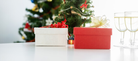 Gift box and decorated Christmas tree with copy space.